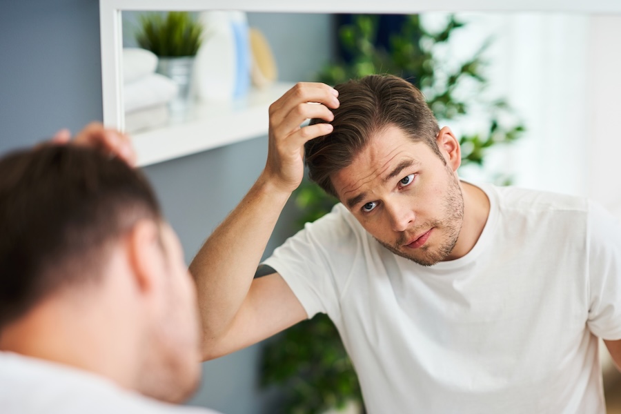 man checking hair growth