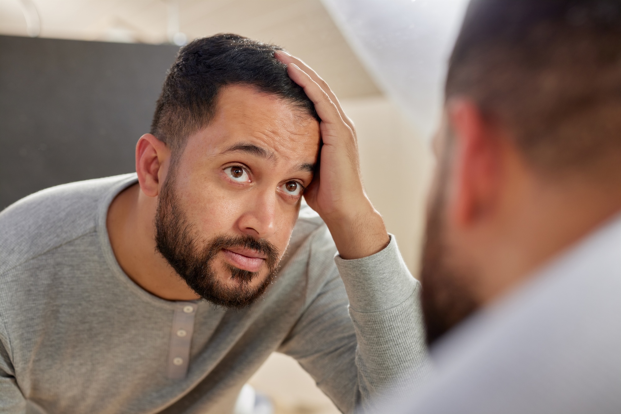 Man examining his hairline