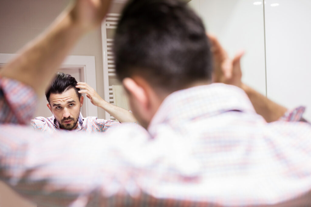 Man applying azelaic acid for hair