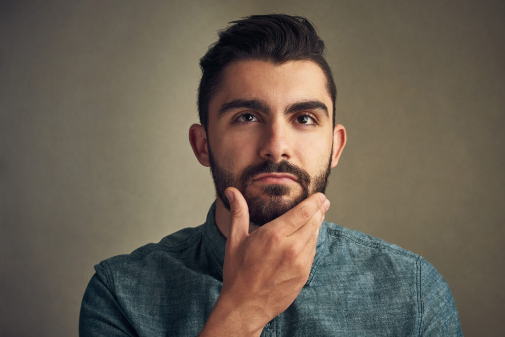 Man examining effect of azelaic acid on beard growth